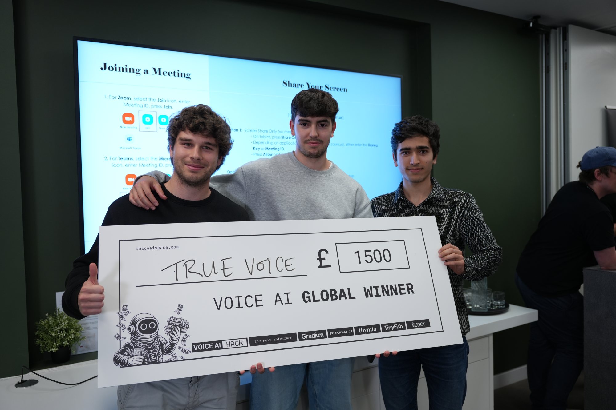 Holding the winner cheque after taking first place.